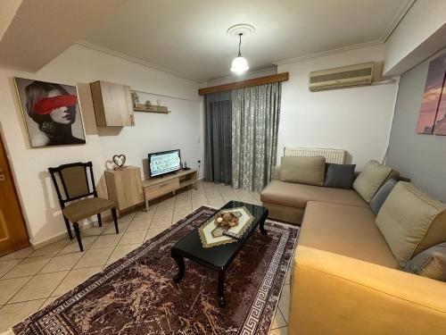 a living room with a couch and a table at Bratis House 3 in Vartholomio
