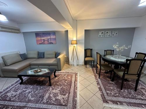 a living room with a couch and a table at Bratis House 3 in Vartholomio