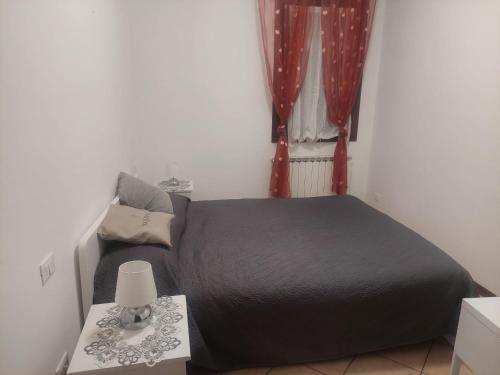 una camera con letto e tavolo con lampada di Alloggio Turistico Artu' a Rovigo