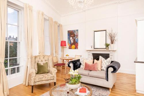a living room with a couch and two chairs at The Berkeley Square Hotel Bristol in Bristol