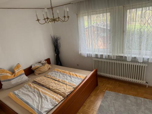 um quarto com uma cama num quarto com uma janela em Haus mit Pool und Panoramablick em Hirschaid