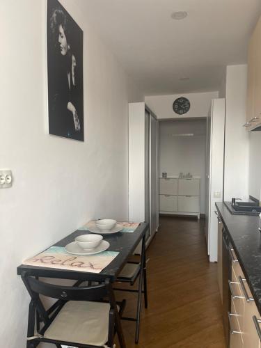 a kitchen with a table and chairs in a room at Garsoniera Relax Drumul Taberei in Bucharest
