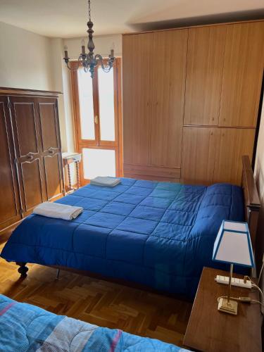 a large blue bed in a bedroom with a table at Iria Chianti Home in Strada