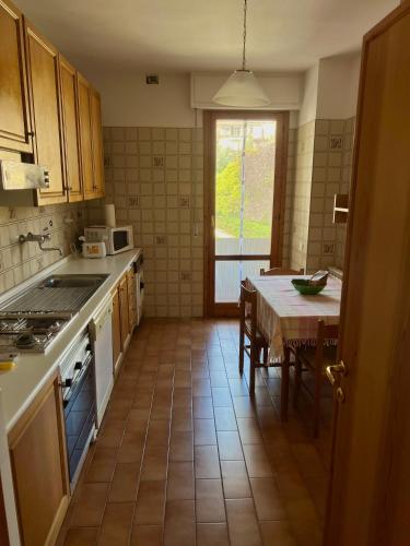 a kitchen with a table and a stove top oven at Iria Chianti Home in Strada