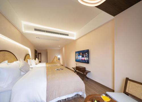 a hotel room with a large bed and a tv at Lingxi Riverview Boutique Homestay - Phoenix Ancient Town in Fenghuang