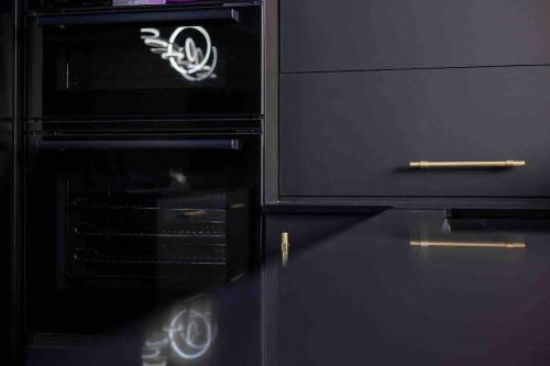 a black oven with a cigarette on top of it at Luxury Couples Get-Away Glasgow in Knightswood