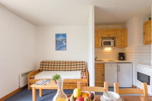 Cette petite chambre comprend une cuisine et une table avec des fruits. dans l'établissement Cote Brune 5 - F4 - Studio bonne expo - 4 pers, à Les Deux Alpes