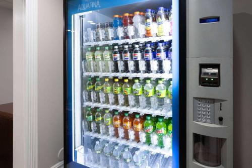 a refrigerator filled with lots of bottles of water at Baymont by Wyndham Budd Lake in Budd Lake