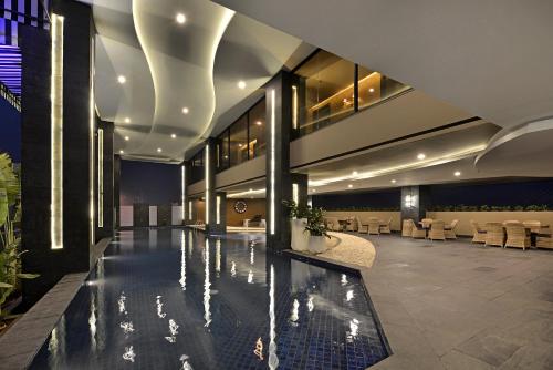 a lobby with a swimming pool in a building at Amaroossa Grande in Bekasi