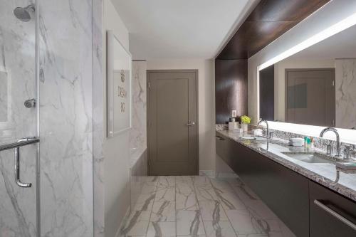 a bathroom with two sinks and a shower at Hyatt Centric Midtown Atlanta in Atlanta