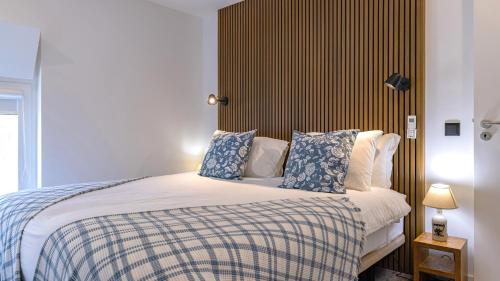 a bedroom with a bed with blue and white pillows at Amazing 3BDR Duplex in Lisbon by LovelyStay in Lisbon