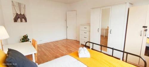 a small bedroom with a bed and a mirror at Maple House near Wembley Stadium in London