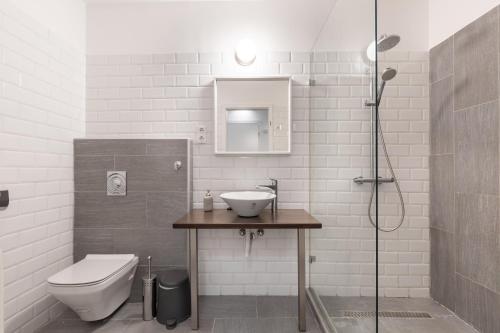 a bathroom with a sink and a toilet and a shower at Downtown Nature Apartment in Budapest