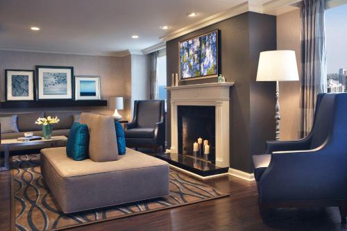 a living room with a couch and a fireplace at Hilton Chicago in Chicago