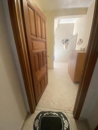 a room with a door and a rug on the floor at ZoYa ‘s Apartments in Agria