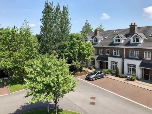 an aerial view of a house with a car parked in the driveway at 74 - 4 Bed Townhouse With Parking by Shortstays in Galway