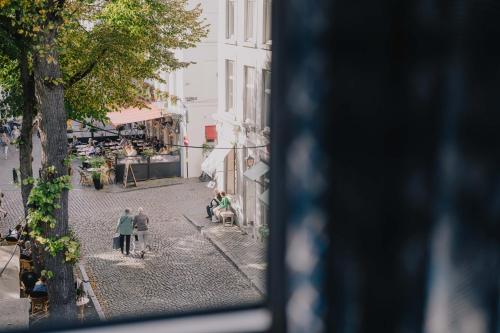 a group of people standing on a street at Derlon Hotel Maastricht in Maastricht