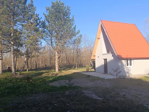a small white chapel with an orange roof at Vikendica Kelebija in Subotica