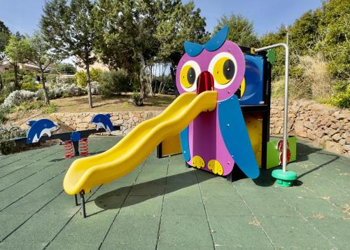 a playground with a slide in a park at VILLA AMIRA Porto Cervo con vista Mozzafiato sul Mare,Piscina Privata,WELLNESS & SPA in Liscia di Vacca