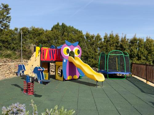 a childrens playground with a slide and a play structure at VILLA AMIRA Porto Cervo con vista Mozzafiato sul Mare,Piscina Privata,WELLNESS & SPA in Liscia di Vacca