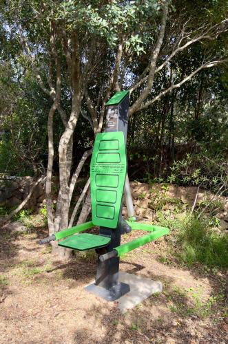 a green sign in front of a tree at VILLA AMIRA Porto Cervo con vista Mozzafiato sul Mare,Piscina Privata,WELLNESS & SPA in Liscia di Vacca
