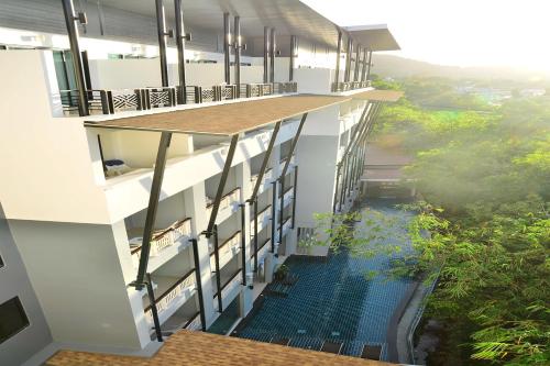 an overhead view of a building with a swimming pool at The Par Phuket SHA Plus in Kathu