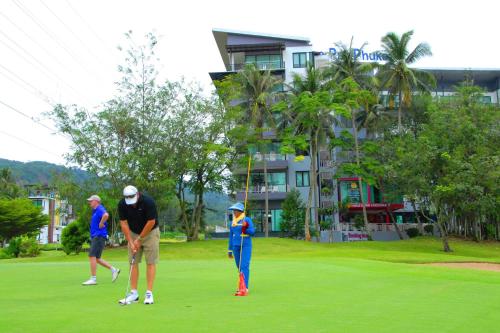 a group of people playing golf on a golf course at The Par Phuket SHA Plus in Kathu