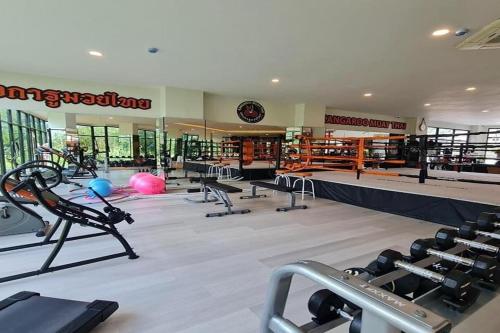 a gym with several treadmills and machines in it at The Par Phuket SHA Plus in Kathu