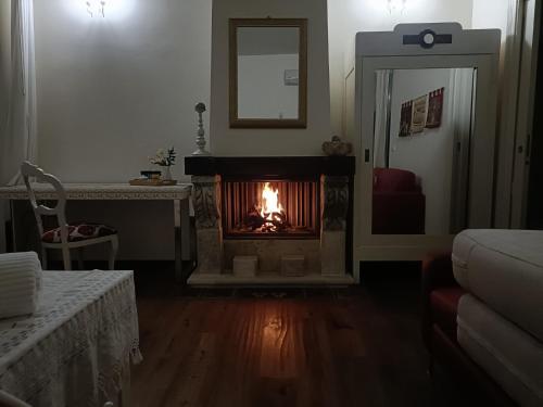 a living room with a fire in a fireplace at Terrazza Romanelli Suites in Bitonto