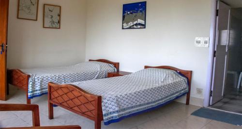 a room with two beds in a room at Camellia Heights 1&2 in Coonoor