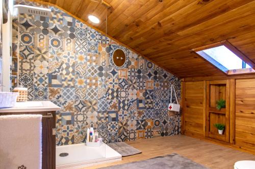 a bathroom with a sink and a tile wall at Casa da Lena in Batalha