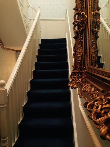 a stairway with a mirror and a stair case at The Georgian Town House Hotel in Liverpool