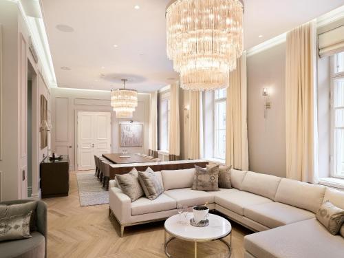a living room with a couch and a dining room at The Hotel Maria Helsinki in Helsinki