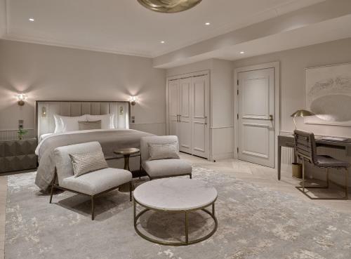 a bedroom with a bed and a table and a desk at The Hotel Maria Helsinki in Helsinki