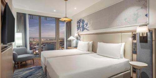 a hotel room with a bed and a large window at Hilton Mall Of Istanbul in Istanbul