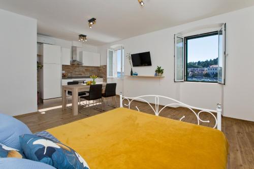 a living room with a blue couch and a yellow rug at Hvar sea view apartment in Hvar