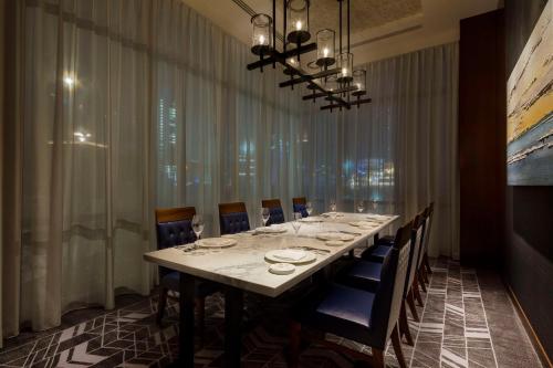 a dining room with a long table and chairs at Hilton Yokohama in Yokohama