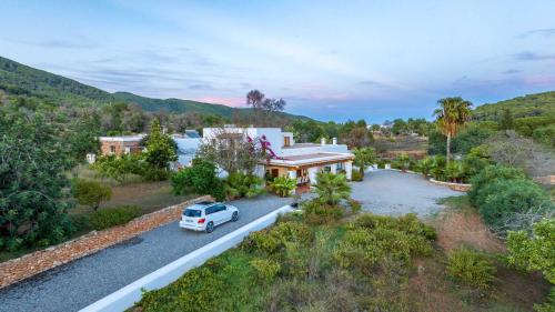 an aerial view of a house with a car parked on a road at Can White in Sant Carles de Peralta