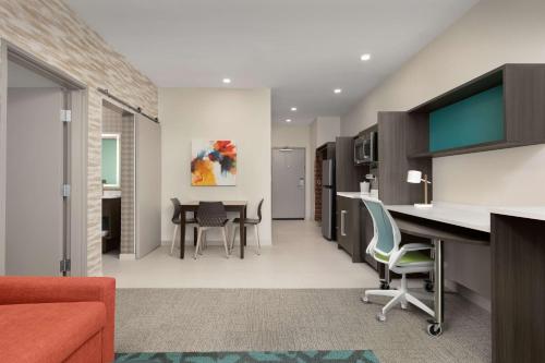 an office with a desk and chairs and a table at Home2 Suites By Hilton Abilene Southwest in Abilene