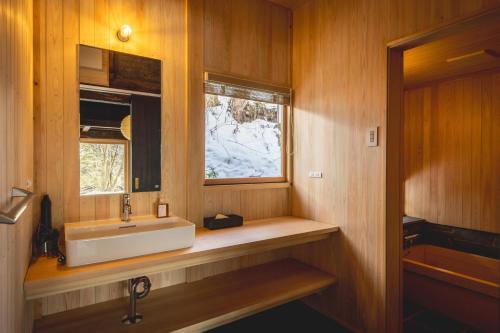 a bathroom with a sink and a window at awai 戸隠 in Nagano