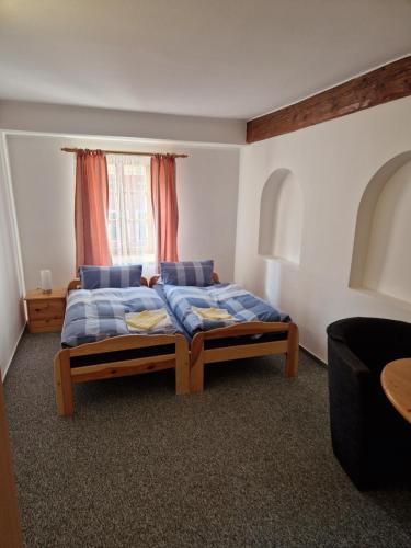 a bedroom with a bed and a window at Pension U Martina in Domažlice