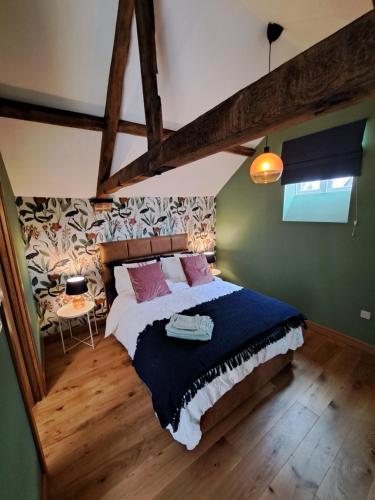 a bedroom with a large bed with a blue blanket at Wilde Escapes in Weston