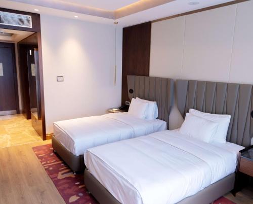 Ένα ή περισσότερα κρεβάτια σε δωμάτιο στο Hilton Samarkand Regency