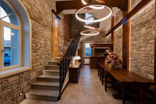 a dining room with a brick wall at Accomodation Hotel Castello Il Codirosso in Cesate