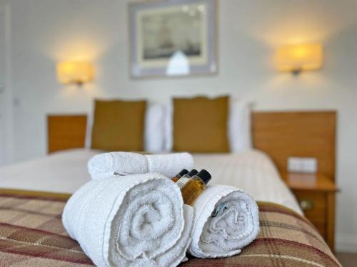 a hotel room with towels on a bed at The Glengower in Aberystwyth