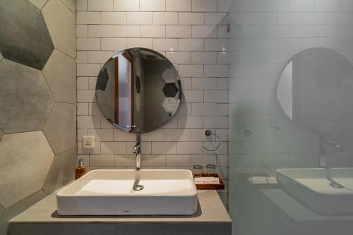 a bathroom with a sink and a mirror at The Nani in Ubud
