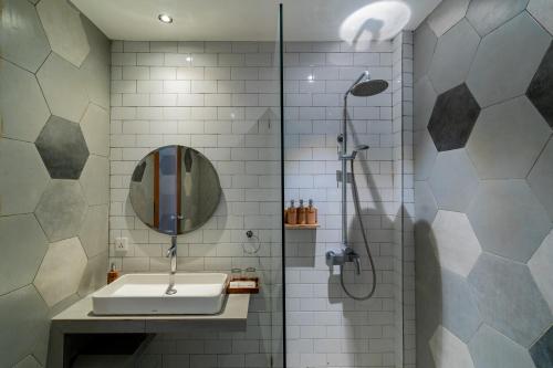 a bathroom with a sink and a shower at The Nani in Ubud