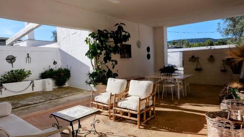 un soggiorno con sedie e tavolo di Masseria Pezze Galere Piscina privata a Montalbano