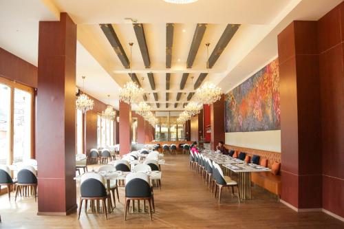 a large dining room with tables and chairs at Kaachi Grand Hotel in Paro