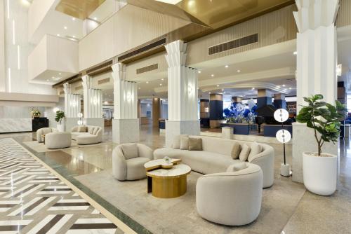 a lobby with couches and tables in a building at Twin Towers Hotel in Bangkok